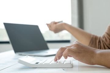 work from home, The hand of a woman who works in finance sits at his desk at home and calculates financial graphs showing the results of his investments, planning the steps of his business growth