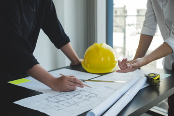 Team of engineers and architects, working team, meeting, discussing construction and drawing construction plans, printing, writing on-site construction sites. Home design concept