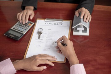 A real estate agent with rental homes and home insurance for clients to sign contracts under a...