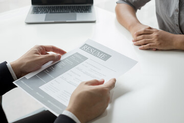 Business people hold a resume and talk to job applicants for job interviews about careers and Their...