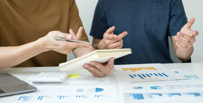 Concept work from home. Two business leaders talk about charts, financial graphs showing results are analyzing and calculating planning strategies, business success building processes