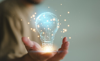 Businessman holding a digital bright light bulb. Concept of Ideas for presenting new ideas Great inspiration and innovation new beginning.