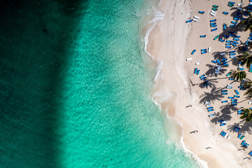 a tropical island with a snow-white beach and a turquoise sea in the Dominican Republic filmed from a drone 