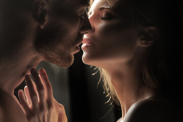 Couple in love face to face, tender hugging and kissing. Beautiful woman and handsome man...