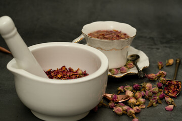 Rose petals in mortar and pestle for rose tea