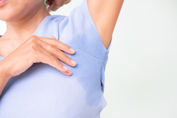 Woman wet shirt underarm close up. problem Armpit sweat stains and strong body odor. hyperhidrosis...