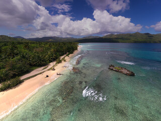 Fototapeta premium a tropical island with a snow-white beach and a turquoise sea in the Dominican Republic filmed from a drone 