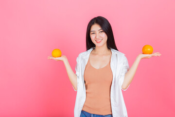 asian young pretty woman happy smile with orange fruit Vitamin C, beauty clean fresh skin, face care, facial treatment, lifestyle and healthy food concept.