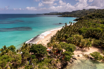 a tropical island with a snow-white beach and a turquoise sea in the Dominican Republic filmed from a drone 