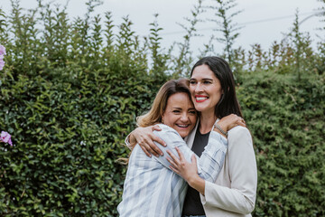 Two latin women friends hugging at terrace office in Mexico Latin America	