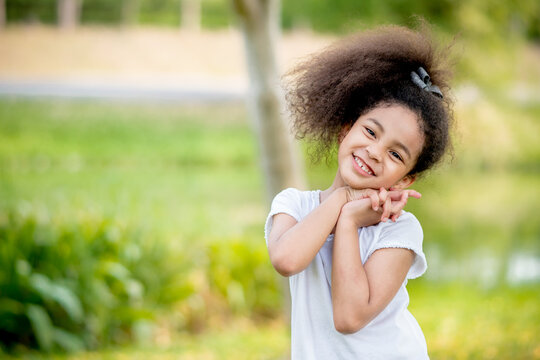 little girl praying happy relax in weekend holiday lifestyle park outdoor nature background.