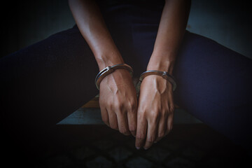 violence crime and kidnapping people concept, criminal tying woman hands with handcuffs.