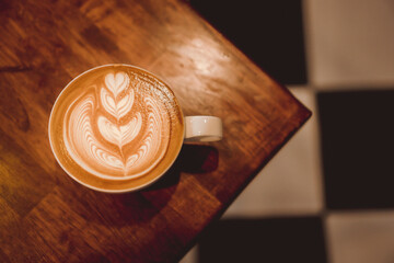 coffee latte art on wood table, relax time, cafe barista art top view.