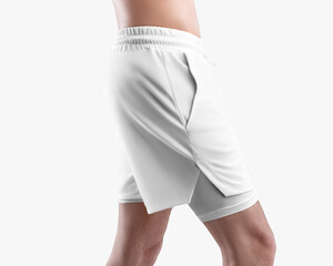 Mockup of white men's loose shorts with pockets, compression lining, stretch underpants, side view, isolated on background.