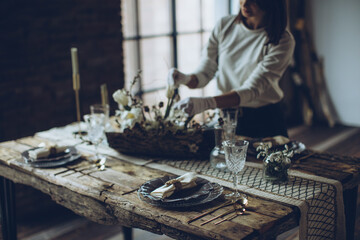 Table setting. A woman decorates the table for the holiday. High quality photo