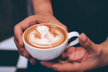 Cup of coffee latte art with coffee shop.