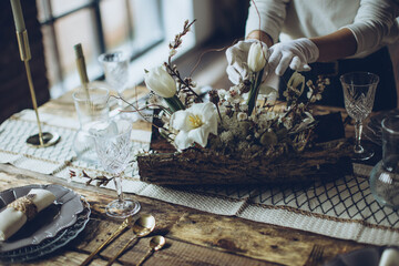 Table setting. A woman decorates the table for the holiday. High quality photo