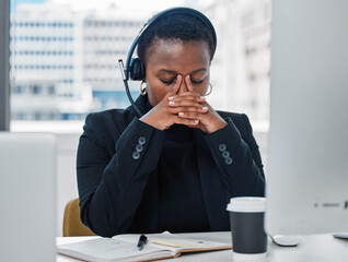 If the problem cannot be solved worrying will do you no good. Shot of a young woman feeling stressed while using a headset and computer late at night in a modern office.