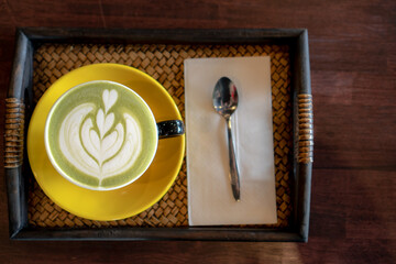 Barista making pouring stream milk with green tea, latte art.
