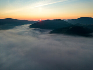 Fototapeta na wymiar Sunrise over the fog in the Ukrainian Carpathians. Aerial drone view.