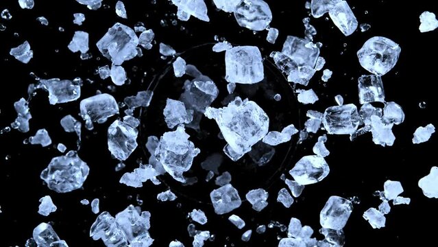 Super slow motion of rotating crushed ice on black background. Splashing water. Filmed on high speed cinema camera, 1000 fps. Speed ramp effect.