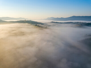 Morning mist in Ukrainian Carpathian mountains. Aerial drone view.