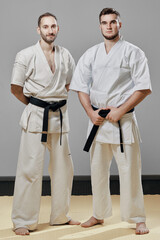 two men karate martial arts trainers banner in fighting stance