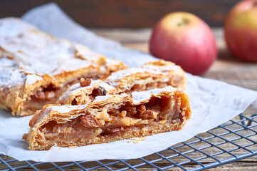 Homemade apfelstrudel apple pie. Closeup of apple strudel cake with raisins and powdered sugar. Austrian apfelstrudel apple strudel pie.