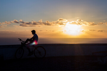 Fototapeta na wymiar Boy on bike during sunset