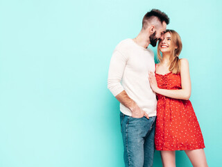 Sexy smiling beautiful woman and her handsome boyfriend. Happy cheerful family having tender moments near blue wall in studio.Pure cheerful models hugging.Embracing each other. Cheerful and happy