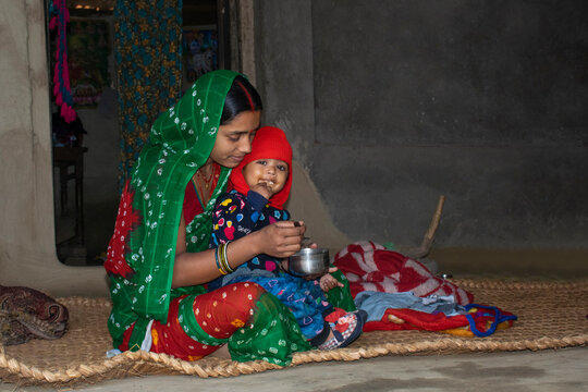 mother feeding her child, mother and child, rural, India