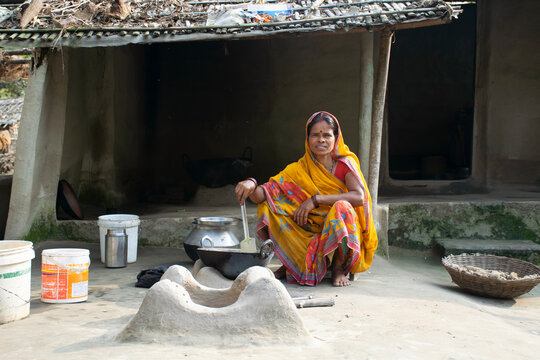 Rural Indian Woman cooking food in the Kitchen using firewood stove