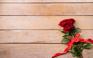 Red roses bouquet with copy space top view on wooden background