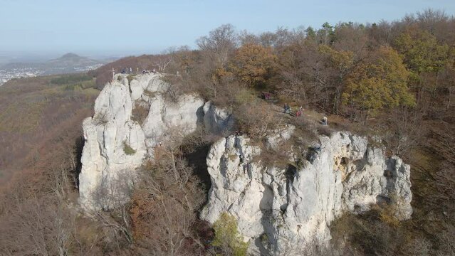 Aerial view zooming out of climbing rock and forest in Swabian Alb, Germany