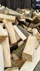 many bars of wood with moss lie in a pile in the yard