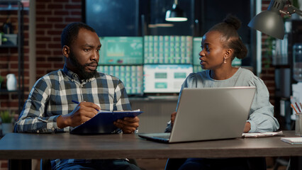 Man and woman doing teamwork to develop new trade sales with capital profit and hedge fund exchange. Working on laptop computer to plan stock market growth, to buy and sell money.