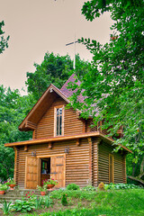 Old Church Building in Dukora Village Estate in Belarus With Line of Flowers and Plants In Foreground