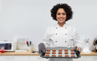 cooking, culinary and bakery concept - happy smiling female chef or baker in white jacket holding...