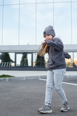 a blond-haired little girl in comfortable clothes dancing