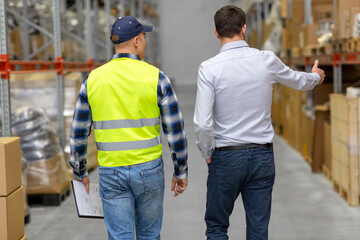 wholesale, logistic business and people concept - manual worker with clipboard and businessman...