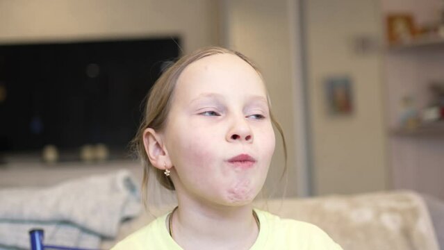 a funny little girl chews japanese roll with her mouth full. good appetite and junk food in the dry. lessons of etiquette and rules of conduct at the table.
