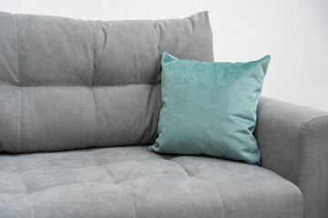 turquoise pillow on a stylish gray sofa, living room furniture