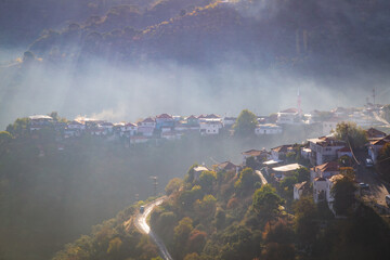 Village landscape in foggy mountain