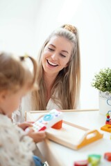 Young beautiful mother playing with her daughter at home.