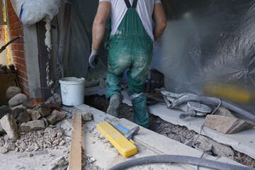 A man worker moving out crushed stones in bucket.
