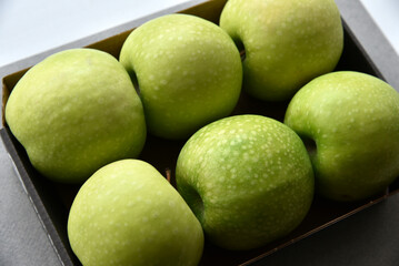 Green apples in the background close-up