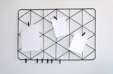 Moodboard with white list and black triangular lattice on grey background