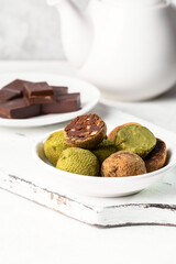 Truffle sweets with dark chocolate and white chocolate with matcha tea