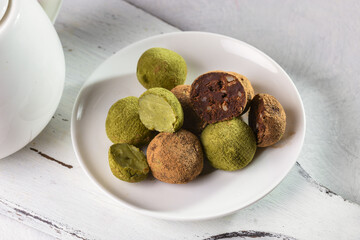Truffle sweets with dark chocolate and white chocolate with matcha tea