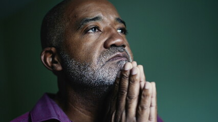 An older Brazilian man praying to God